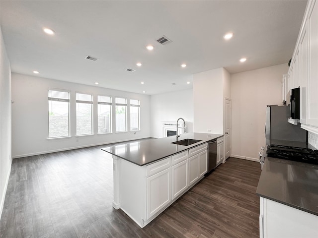 kitchen with dark wood-type flooring, white cabinetry, sink, and stainless steel appliances