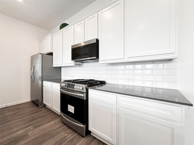 kitchen featuring tasteful backsplash, white cabinets, dark hardwood / wood-style floors, and stainless steel appliances