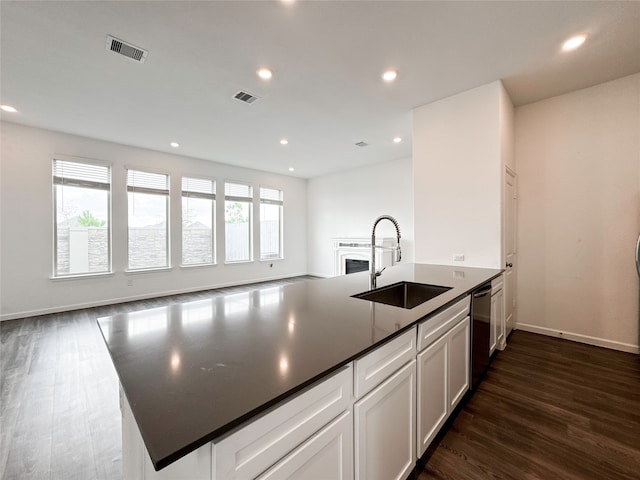 kitchen with dishwasher, dark wood-type flooring, sink, and white cabinets