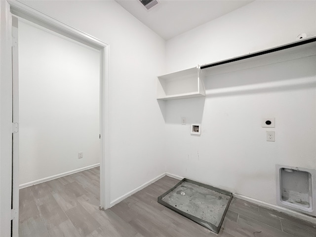 clothes washing area with electric dryer hookup, hookup for a washing machine, and wood-type flooring