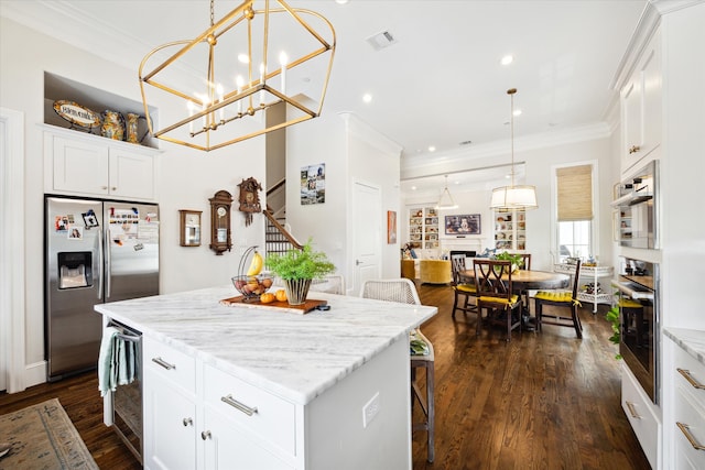 kitchen with stainless steel appliances, a center island, dark hardwood / wood-style floors, white cabinetry, and hanging light fixtures