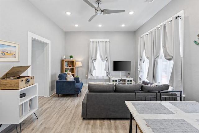 living room with ceiling fan and light hardwood / wood-style floors