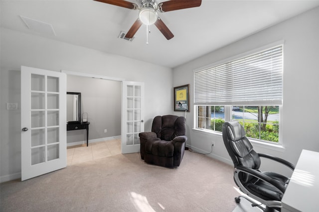 carpeted home office with french doors and ceiling fan