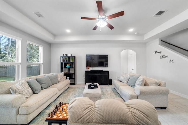 living room featuring light tile patterned flooring and ceiling fan