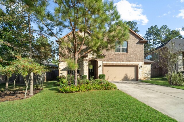 view of front of house with a garage and a front lawn