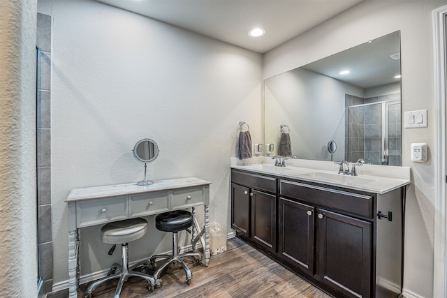 bathroom featuring vanity, an enclosed shower, and wood-type flooring