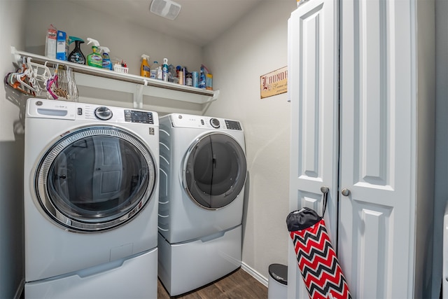 washroom with washer and dryer and dark hardwood / wood-style flooring