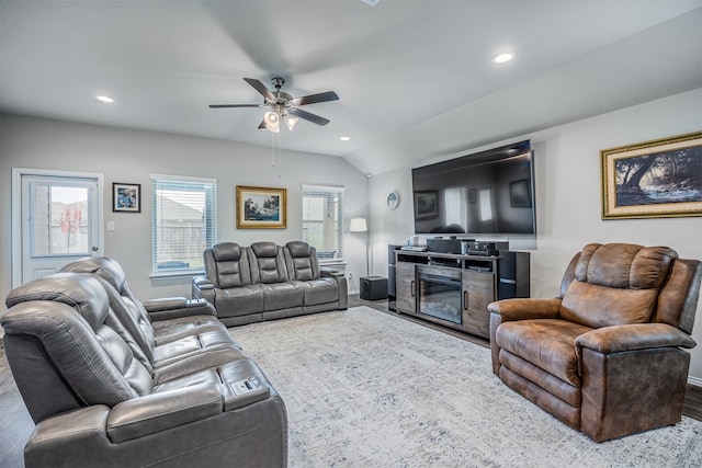 living room featuring hardwood / wood-style floors, ceiling fan, and vaulted ceiling