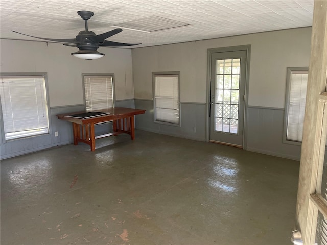 miscellaneous room featuring ceiling fan and concrete flooring