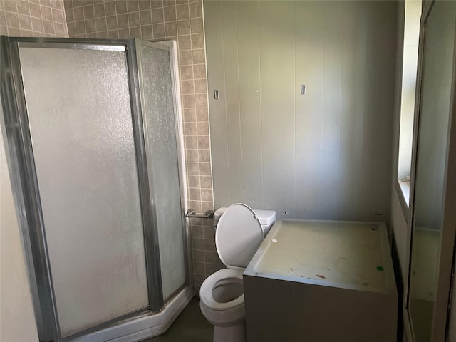 bathroom featuring toilet and an enclosed shower