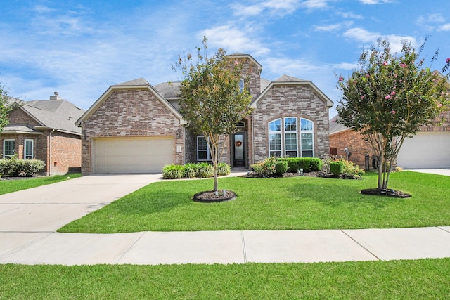 view of front of house with a garage and a front lawn