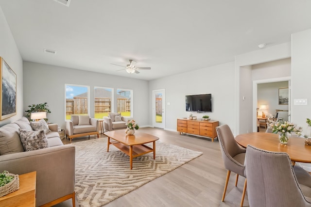 living room with ceiling fan and light hardwood / wood-style floors