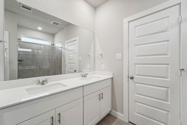 bathroom with vanity, tile patterned floors, and an enclosed shower