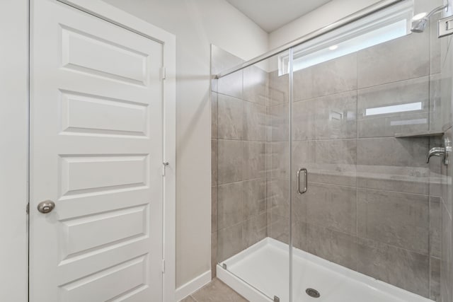 bathroom featuring tile patterned flooring and walk in shower