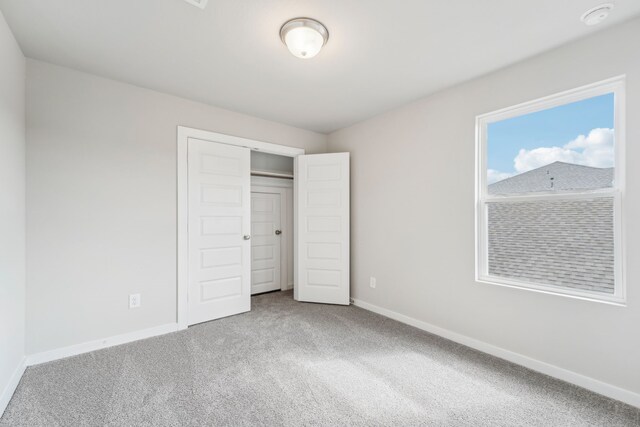 unfurnished bedroom featuring a closet and carpet