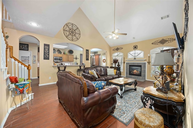 living room featuring a fireplace, dark hardwood / wood-style floors, and high vaulted ceiling