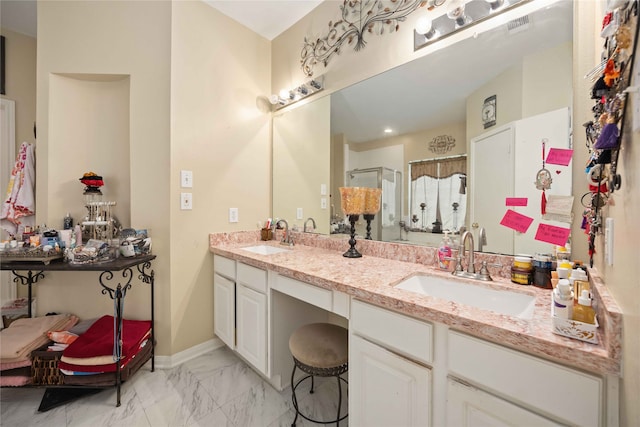 bathroom featuring vanity and a shower with door