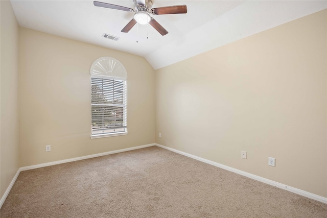 empty room with ceiling fan, carpet flooring, and vaulted ceiling