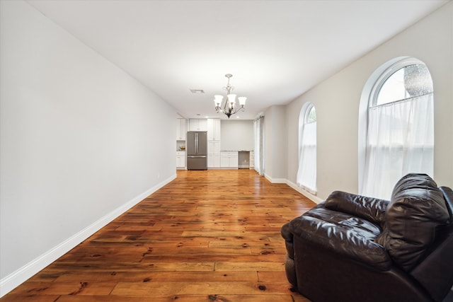 living room with hardwood / wood-style flooring and an inviting chandelier