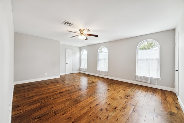 unfurnished room with dark hardwood / wood-style flooring and ceiling fan