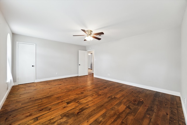 empty room featuring ceiling fan and dark hardwood / wood-style floors