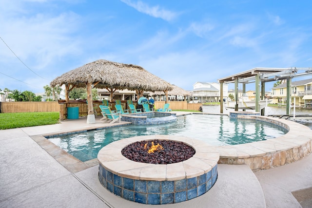 view of pool featuring a gazebo, a patio area, an in ground hot tub, and an outdoor fire pit