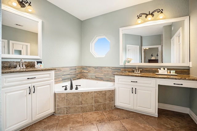 bathroom with vanity and a relaxing tiled tub