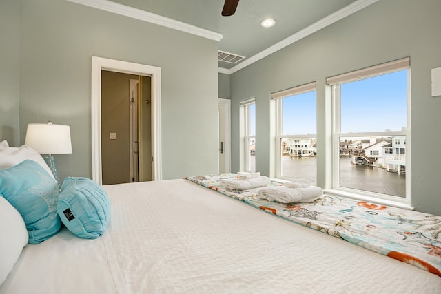 bedroom with ceiling fan, a water view, and crown molding