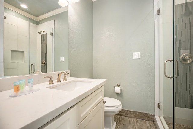 bathroom featuring vanity, toilet, walk in shower, and ornamental molding