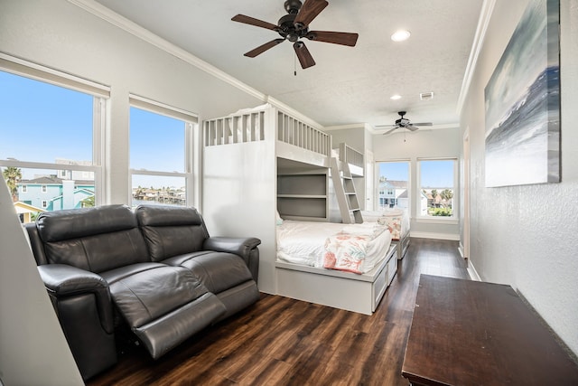 bedroom featuring a textured ceiling, dark wood-type flooring, ceiling fan, and crown molding