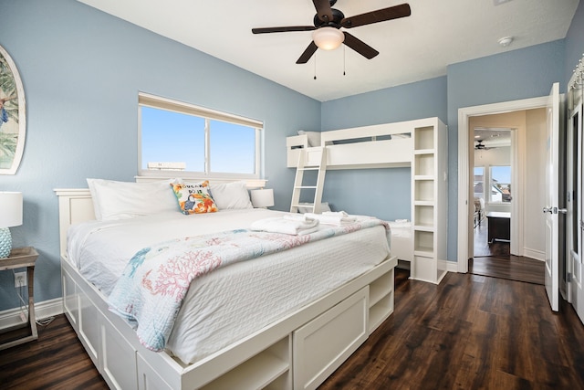 bedroom featuring multiple windows, ceiling fan, and dark wood-type flooring