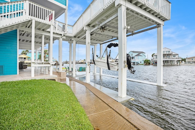 dock area featuring a water view and a lawn