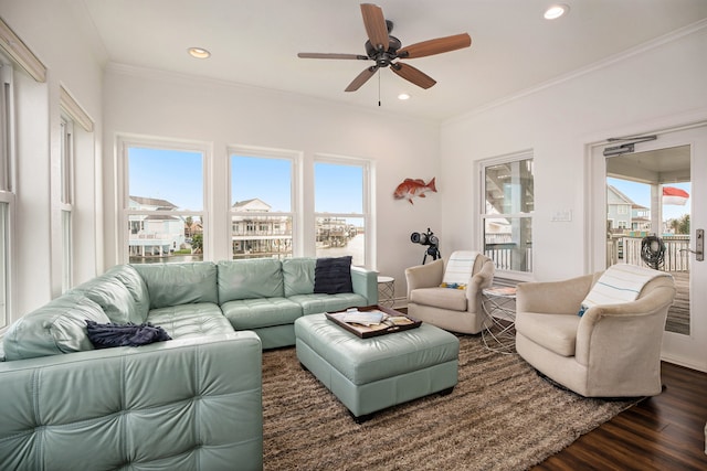 living room featuring dark hardwood / wood-style flooring, ceiling fan, and crown molding