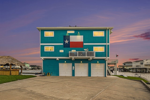 view of front of home featuring a garage and a balcony