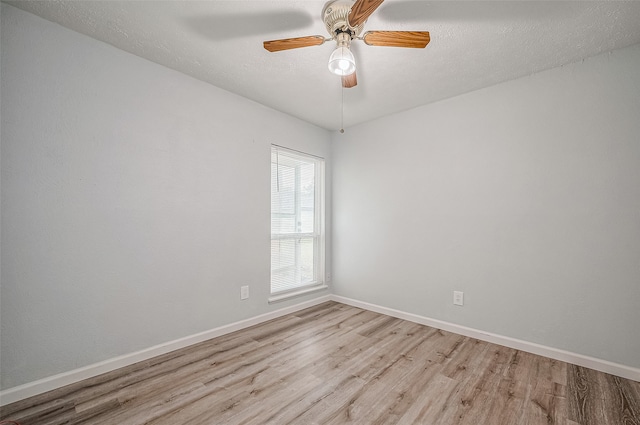 empty room featuring light wood-type flooring and ceiling fan