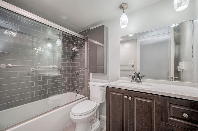 full bathroom featuring enclosed tub / shower combo, vanity, and toilet