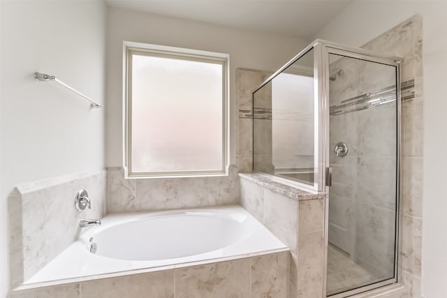 bathroom featuring shower with separate bathtub