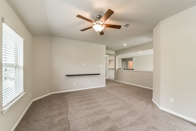 unfurnished living room featuring ceiling fan and light carpet