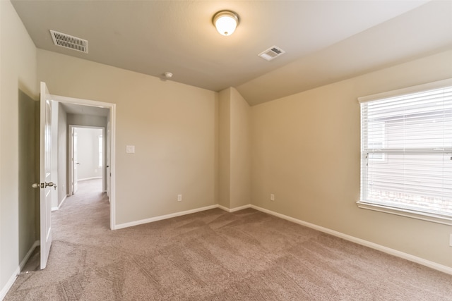 empty room featuring light carpet