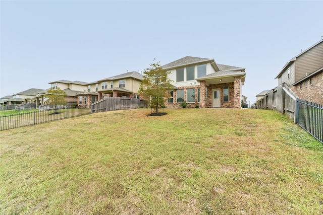 rear view of property with a lawn