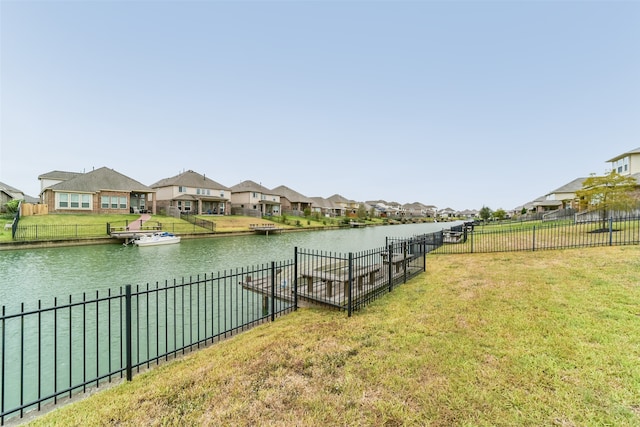 exterior space featuring a lawn and a water view