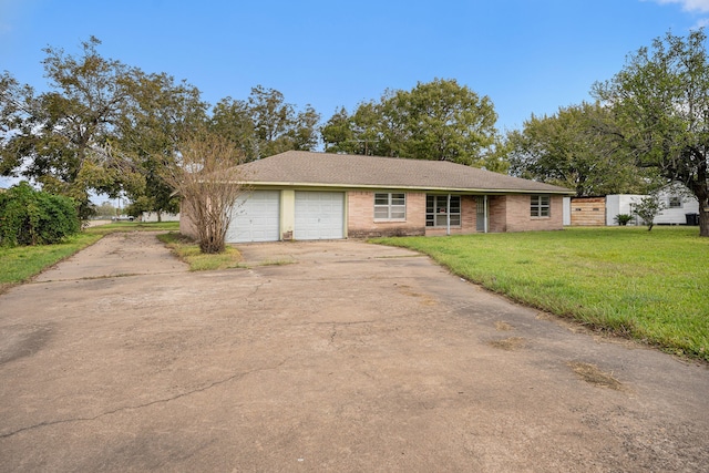 ranch-style house featuring a garage and a front lawn