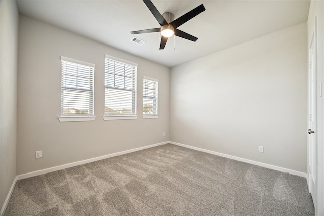 carpeted empty room featuring ceiling fan