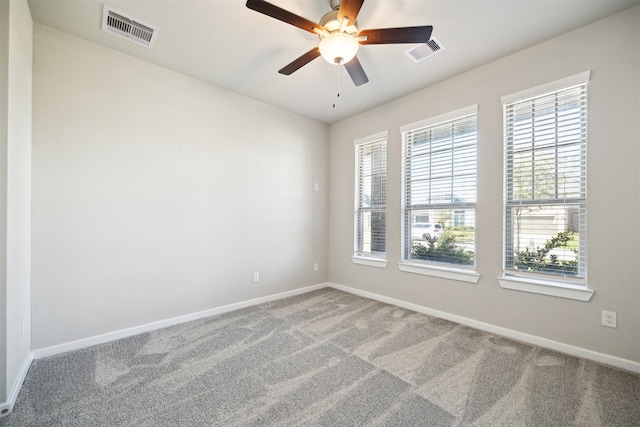 carpeted spare room featuring ceiling fan