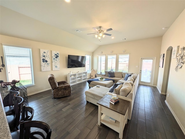 living room featuring lofted ceiling, a healthy amount of sunlight, dark hardwood / wood-style floors, and ceiling fan