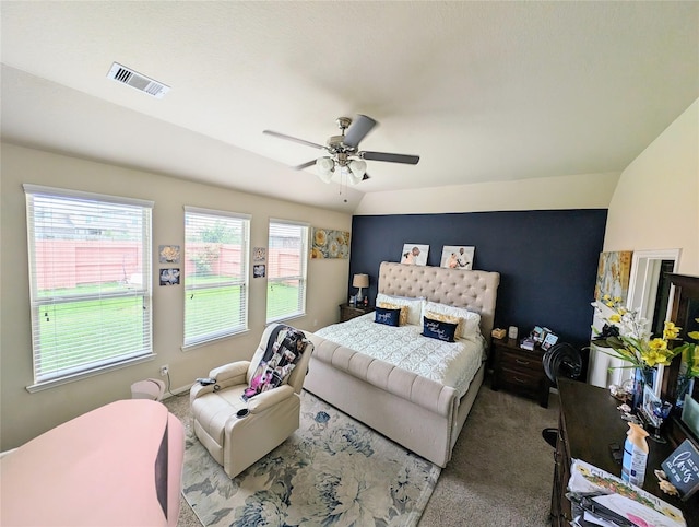 carpeted bedroom with multiple windows, lofted ceiling, and ceiling fan