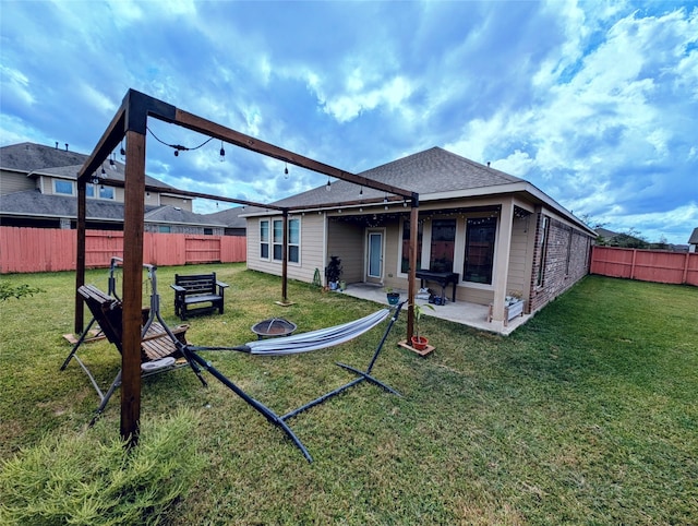 back of property featuring a lawn and a patio area