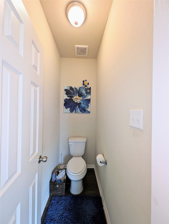 bathroom featuring a textured ceiling and toilet