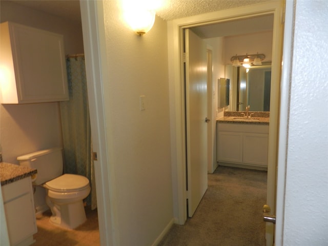 bathroom with vanity, toilet, and a shower with curtain