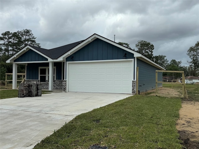 view of front facade with a garage, a carport, a front lawn, and a porch